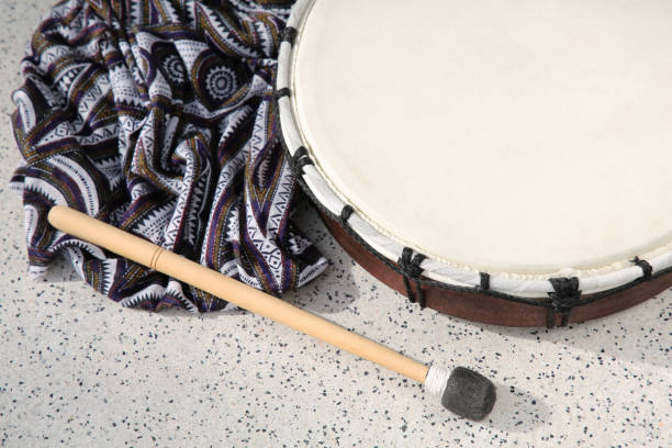 istock Drum and drumstick on grey table, above view. Percussion musical instrument 1496754303