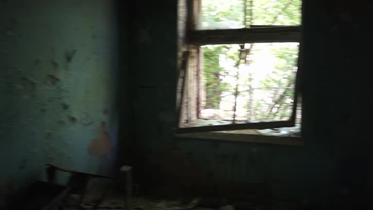 Creepy and Gloomy Abandoned House. Broken windows and doors, walls and floor destroyed by fire