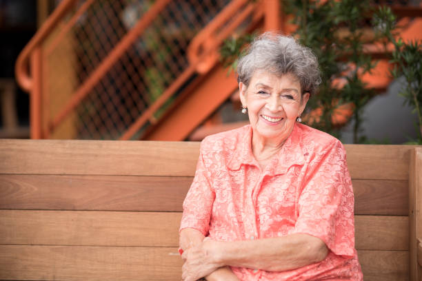 istock Elegant elder woman sitting on a wooden bench 1496754814