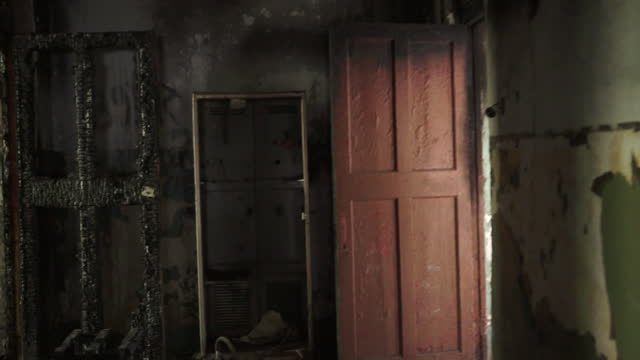 Creepy and Gloomy Abandoned House. Broken windows and doors, walls and floor destroyed by fire