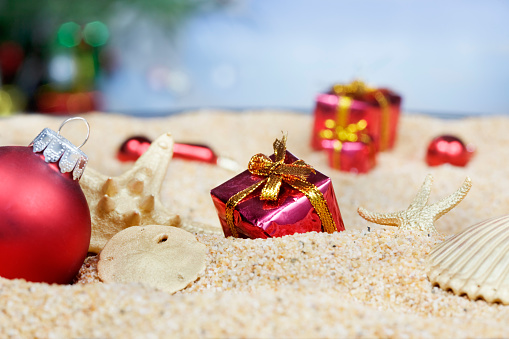Christmas ornaments in the sand - red packages