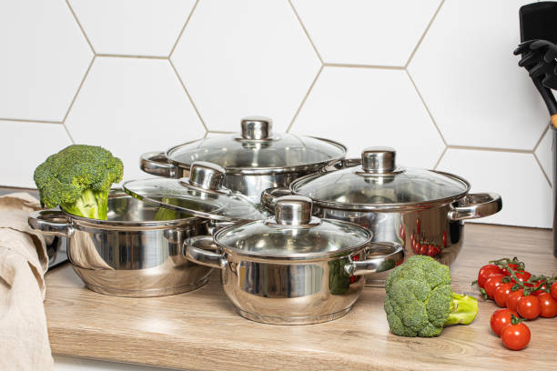 Set of for stainless steel cooking pots on modern kitchen stock photo