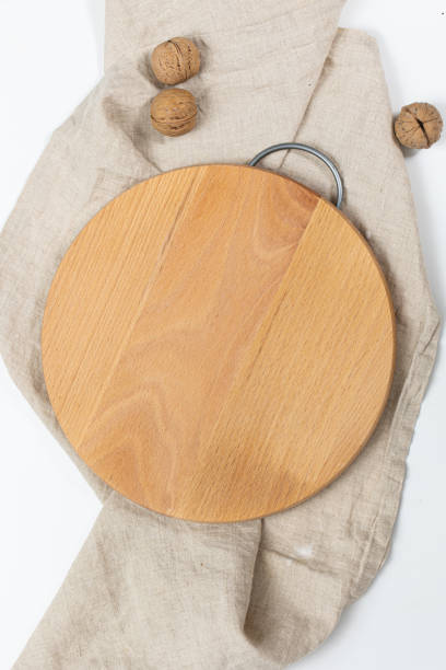 istock Kitchen utensils concept with round empty wooden or bamboo cutting board 1496756704
