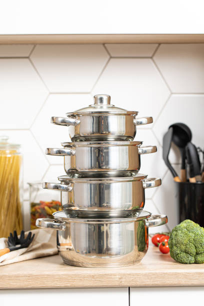 istock Set of for stainless steel cooking pots on modern kitchen 1496757313