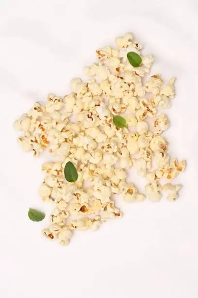 This stock photo features a bowl of freshly-popped white and yellow popcorn