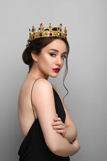 istock Beautiful young woman wearing luxurious crown on light grey background 1496759220