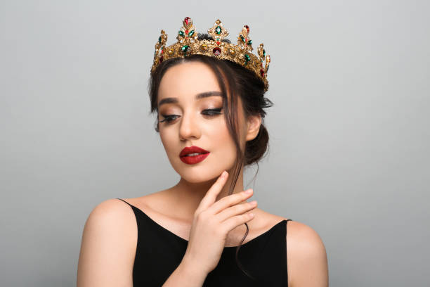 istock Beautiful young woman wearing luxurious crown on light grey background 1496759227