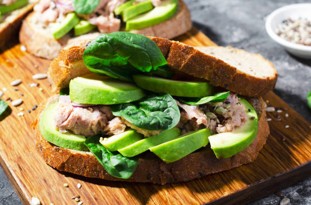 istock Tuna Avocado Sandwich, Healthy Snack or Breakfast on Dark Background 1496759362