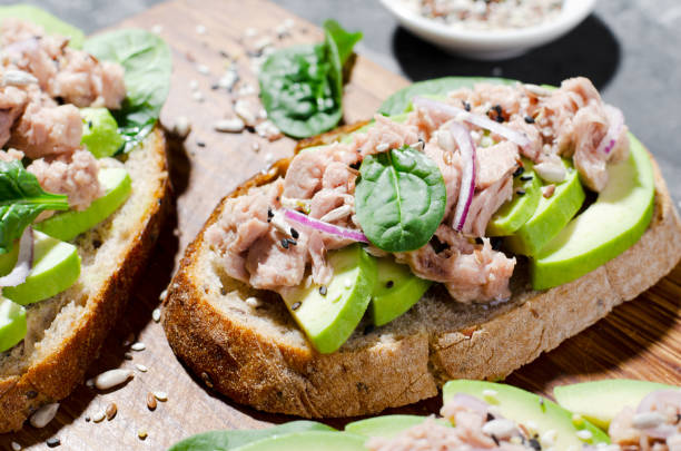 istock Tuna Avocado Toasts, Healthy Snack or Breakfast on Dark Background 1496760656