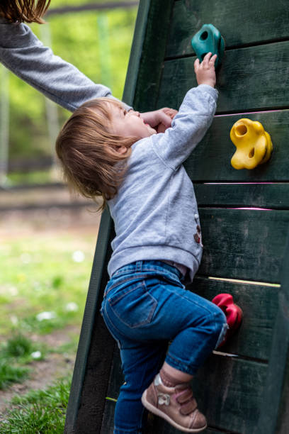 istock a baby is climbing on an artificial rock 1496762693