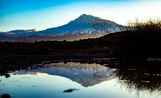istock snowy mountain with landscape at the beautiful sunset 1496763158