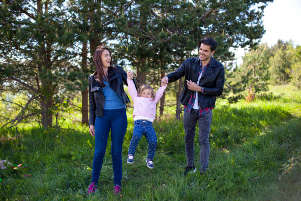 Happy family walking in the forest