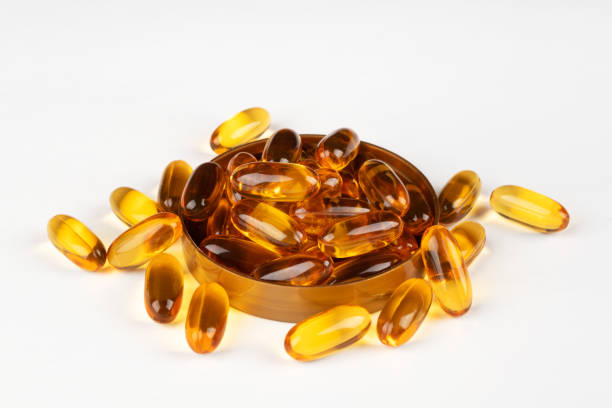 istock Fish oil omega 3 gel capsules on a light background. Close-up. 1496764309