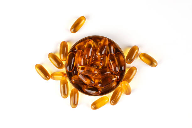 istock Cod liver oil omega 3 gel capsules isolated on white background. 1496764318