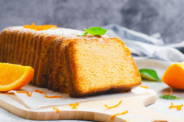 istock Orange Pound Cake, Moist Loaf Cake with Orange Zest on Bright Background 1496764643