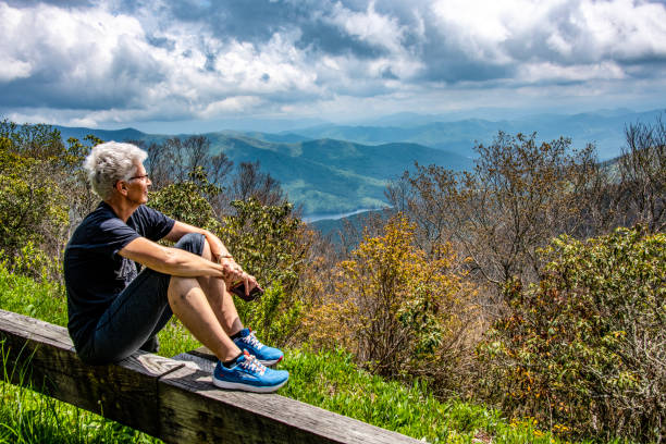 View from the Blue Ridge Parkway. An older female is taking in the mountain views along the Blue Ridge Parkway. robert michaud stock pictures, royalty-free photos & images