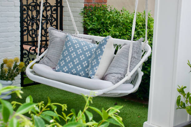 istock White wicker Porch swing and assorted pillows 1496782139