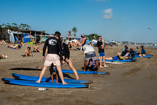 Canggu, Bali, Indonesia People get surfing lessons on the beach.
