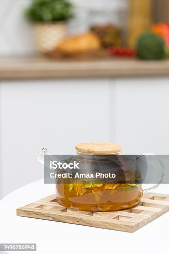 istock Glass refractory teapot with fruit tea in domestic kitchen 1496786948