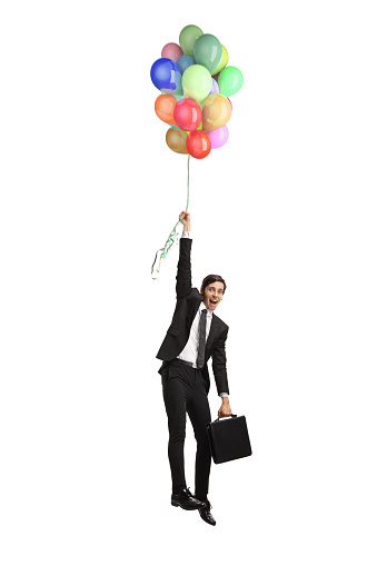 Businessman holding balloons and flying up isolated on white background