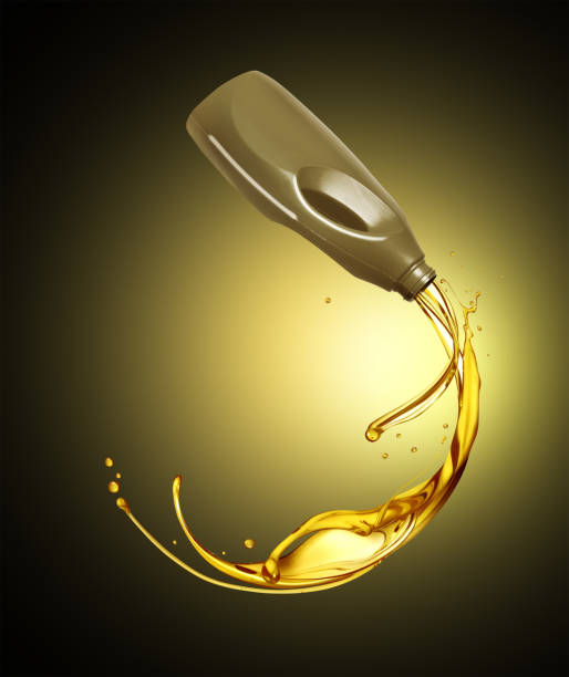 istock Splashes of engine oil pouring from a plastic container on a black background 1496790469