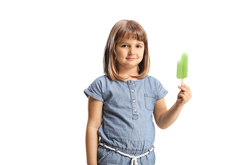 Little girl holding ice cream lollie and smiling at camera isolated on white background