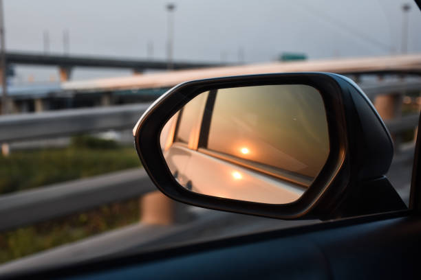 istock Reflection of sun in car mirror. 1496799649