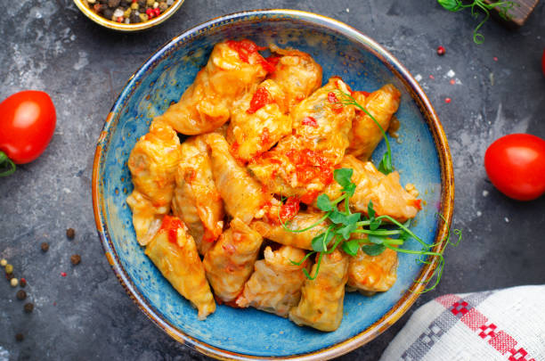 istock Homemade Cabbage rolls with meat, rice and vegetables also known as sarma, golubtsy, dolma on Rustic Background 1496799682