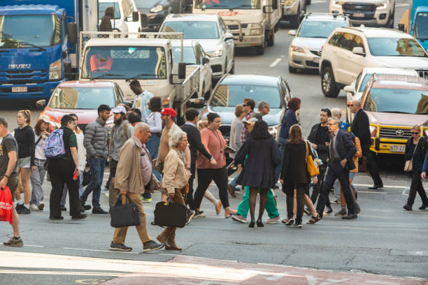 istock Crowd of commuters crossing a CBD street 1496800853