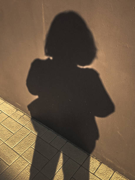 istock Woman standing shadow on the wall. 1496804122