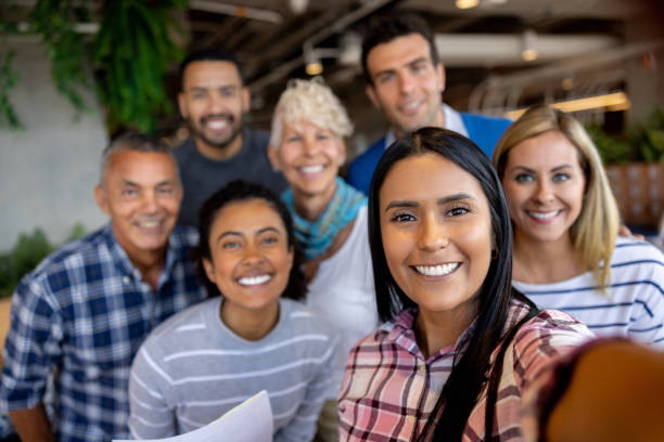 istock Happy business team smiling for a selfie 1496805645