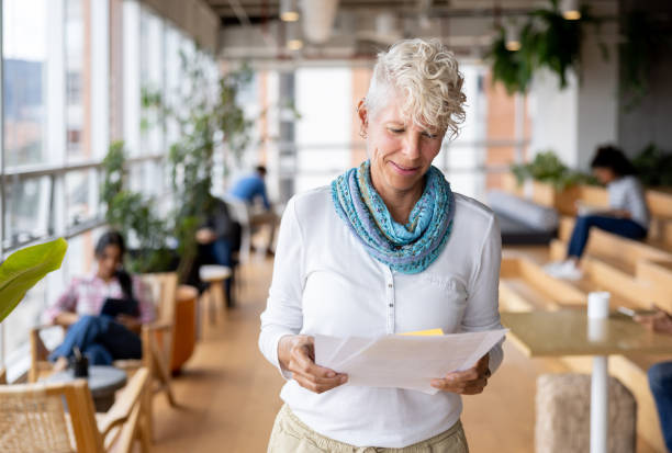 istock Casual businesswoman working at the office and reading documents 1496805657