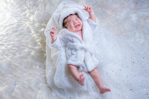 Newborn sleeping. Newborn Babies Sleep in Bed. Lovely sleep of the newborns babies on the bed. Cute twins baby girl is shooting in at home. fashion image of baby and family.