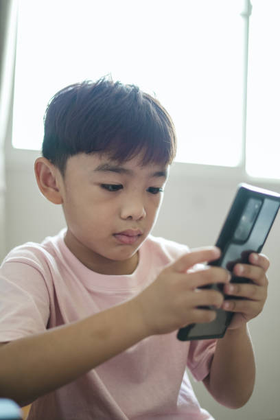 istock Close-up Child Boy using Smart phone at home 1496811088