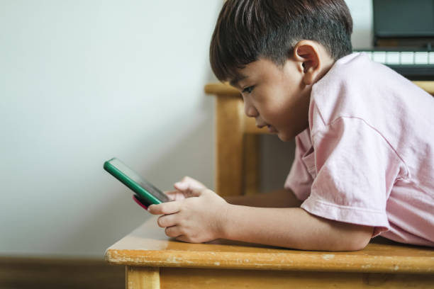 istock boy sleeping on a chair playing mobile phone 1496811131