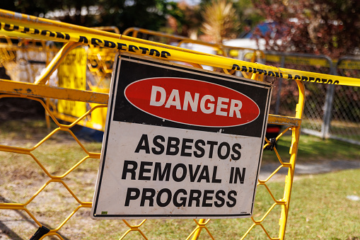 Asbestos removal sign on a demolition site