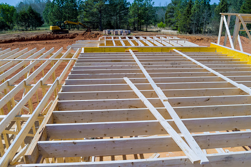 During construction of newly constructed wooden house framing beam supports framework construction layout joists.