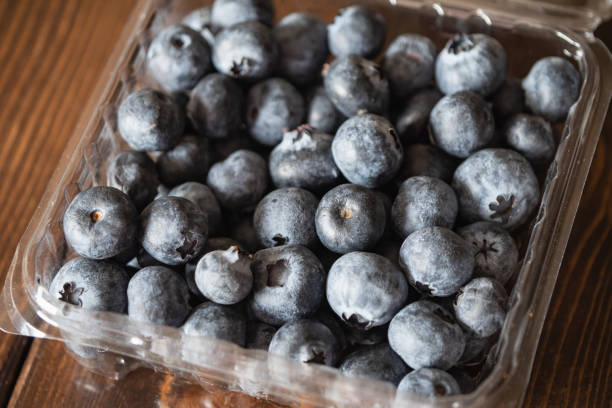 istock Blueberries in a plastic container. Fresh sweet and sour fruits. 1496816346