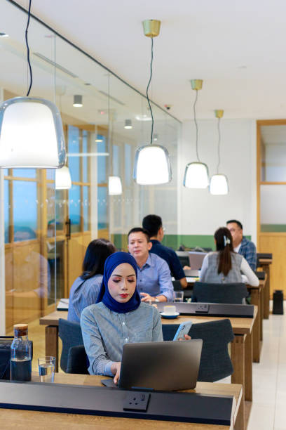 istock A diverse group of Asian and multiracial white-collar workers is busy working in an open-plan co-sharing office. 1496821556