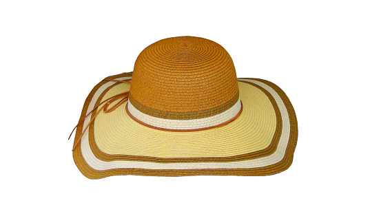 Straw hat isolated. Closeup of a elegant summer straw hat with ribbon for girls isolated on a white background. Travel and vacations concept. Holiday season.
