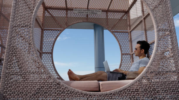 istock Asian male working casually in cabana by the infinity pool in a luxury hotel 1496827151