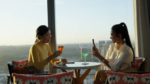 istock Asian individuals having a drink in a bar after business networking session 1496829829