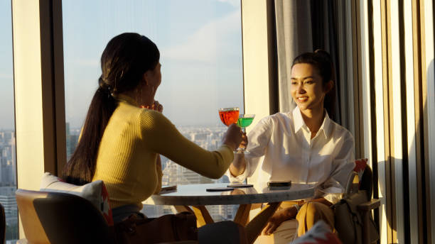 istock Asian individuals having a drink in a bar after business networking session 1496829839