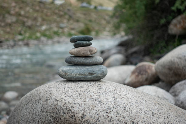 Rocks stack on the coast of summer Mountain River, concept of balance and harmony. stock photo