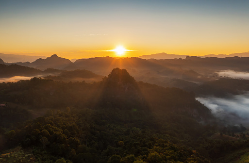 Beautiful aerial view of landscape sunbeam with foggy environment during sunrise at Baan Jabo viewpoint Baan Jabo is one of the most amazing mists in Pang Mapha Mae Hong Son Province of Thailand.