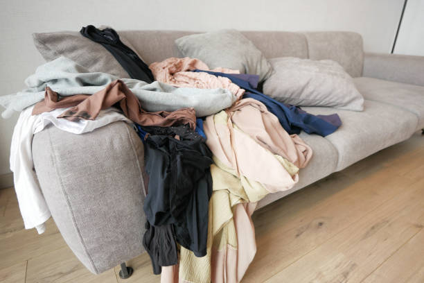 istock Messy clothes on sofa at home 1496832695