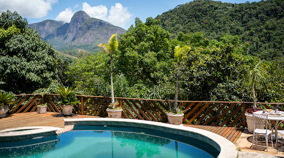 High angle view of a tourist resort poolside situated in tropical forest