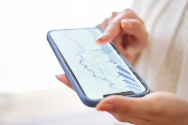 istock A woman's hand checking the exchange chart on her smartphone 1496835192