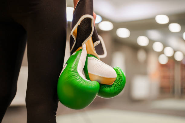 Female boxer holding boxing gloves