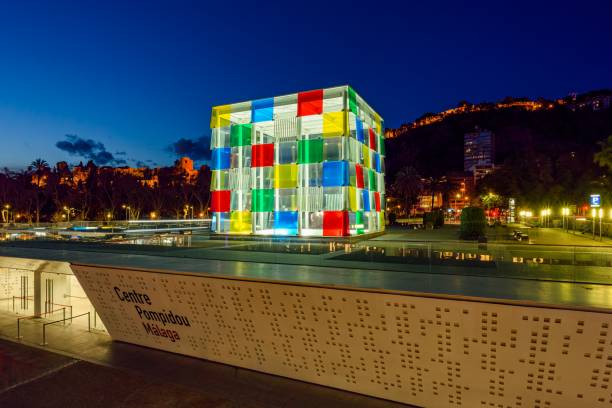 Centre Pompidou at night Málaga, Spain. The Center Pompidou Málaga is located in the remarkable building known as The Cube, between Docks 1 and 2 of the port of the city. A privileged location in front of the waters of the bay of Malaga.